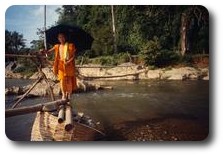 Monk crossing river at Tham Xang near Vang Vieng, Laos