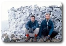 Jon and Kevin crouching on the icy summit of Scafell Pike, Lake District, England