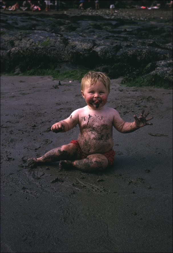 Me eating sand on Pwllgwaelod beach, Wales