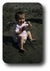 Carolyn eating sand on Pwllgwaelod beach, Wales