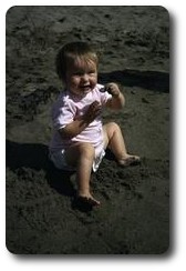 Carolyn eating sand on Pwllgwaelod beach, Wales
