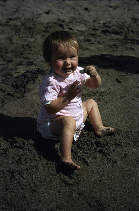 Carolyn eating sand on Pwllgwaelod beach, Wales